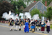 Revolutionary war reenactors fire their weapons